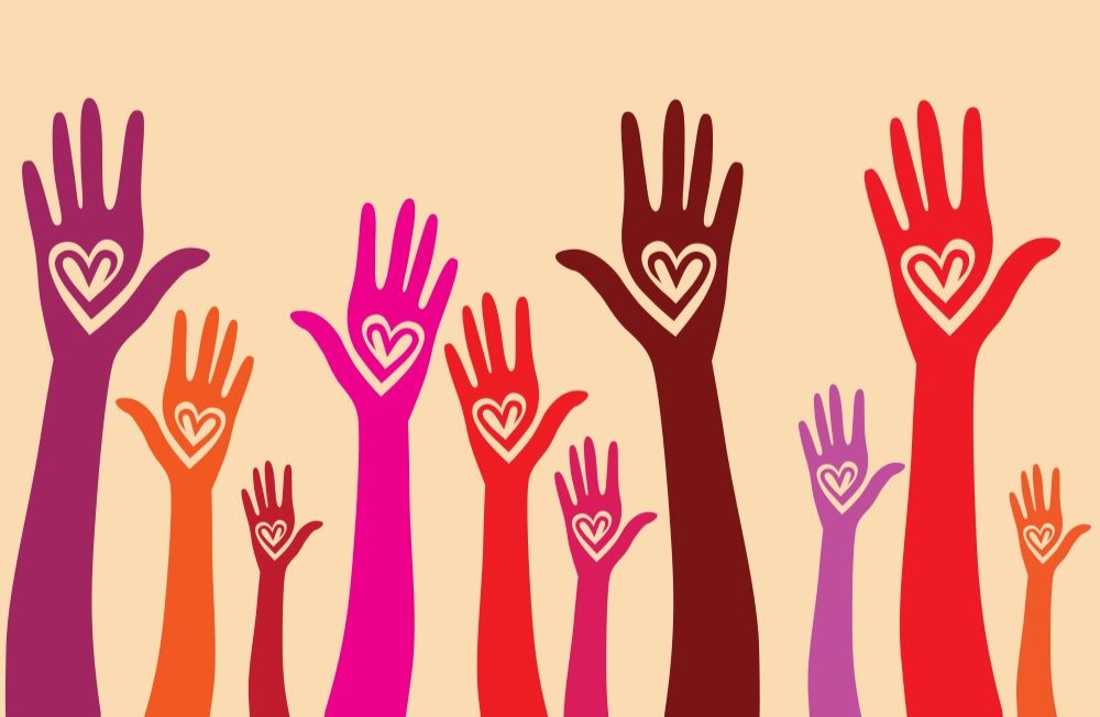 hands with heart motif raised together